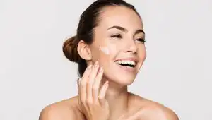 woman-laughing-touching-her-face-skin